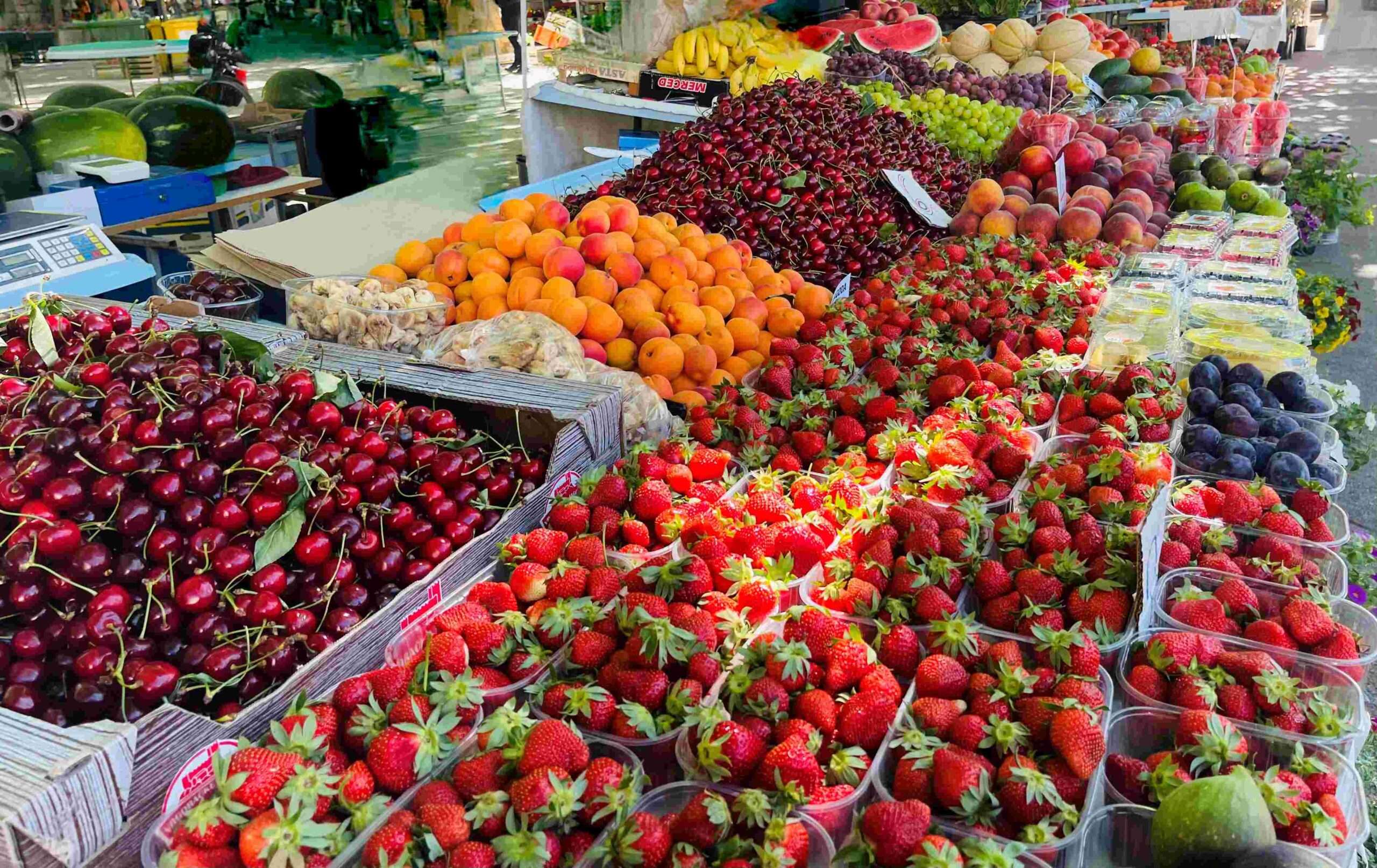 Colorful display of red, orange and peach fruits and vegetables in a farmers market in Split Croatia just outside Diocletian palace